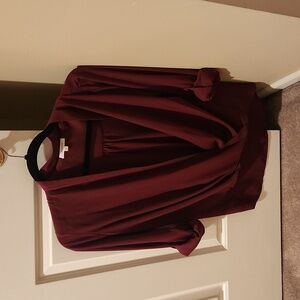 Wrap blouse with front button closure.